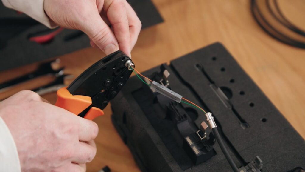 Five reasons to choose repair over replacement. Picture of fibre optic being repaired in a workshop.