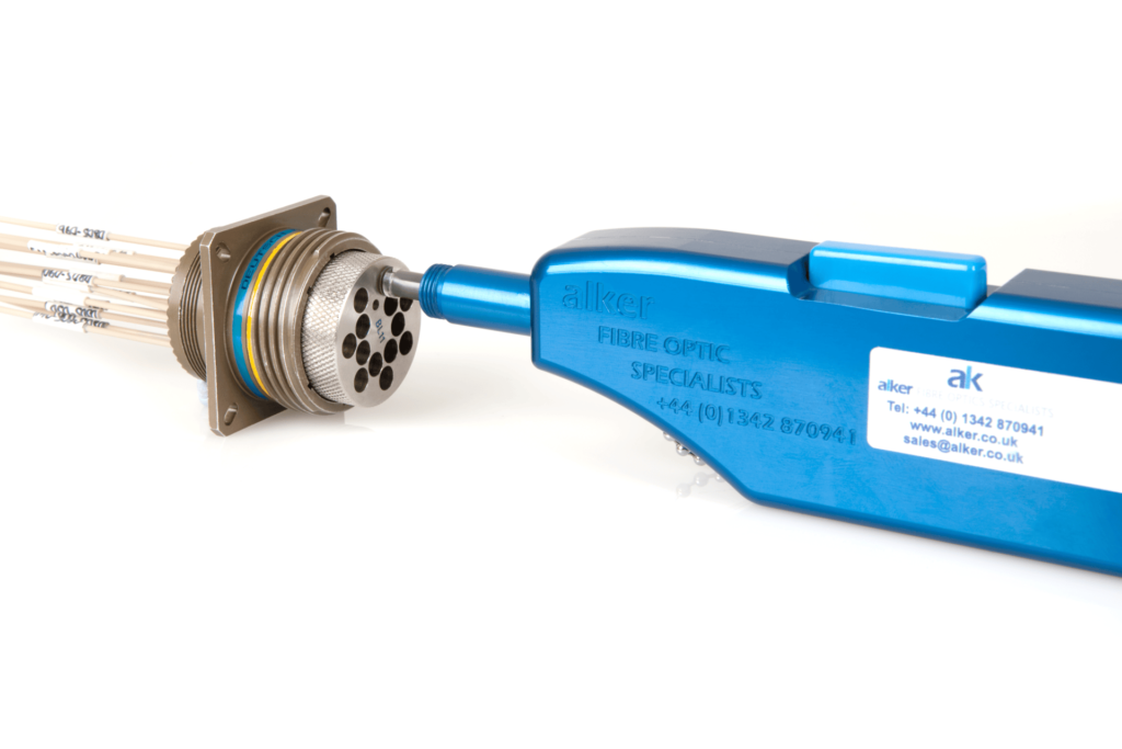 A blue and white fibre optic cleaning kit in action, cleaning a fibre optic connector.